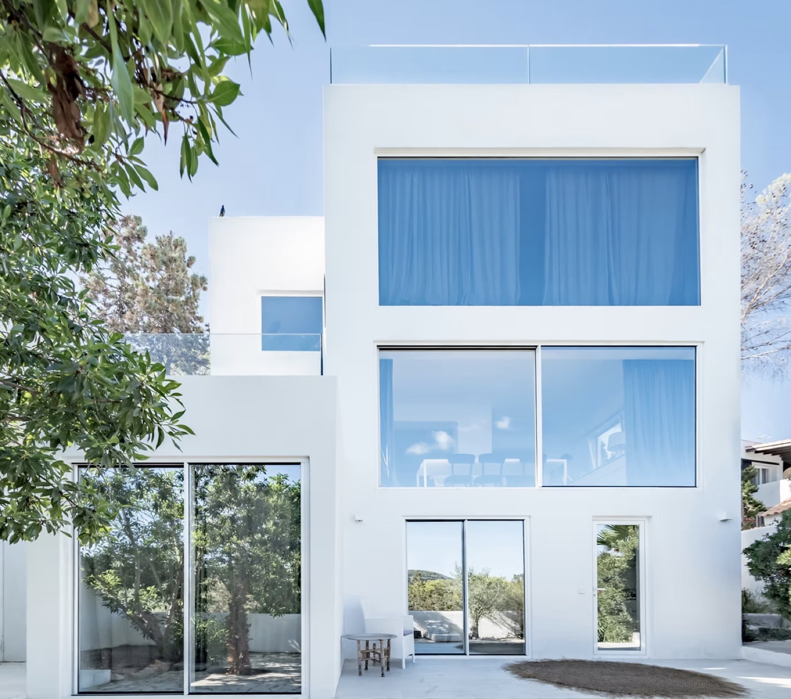 Contemporary white residence among mature trees