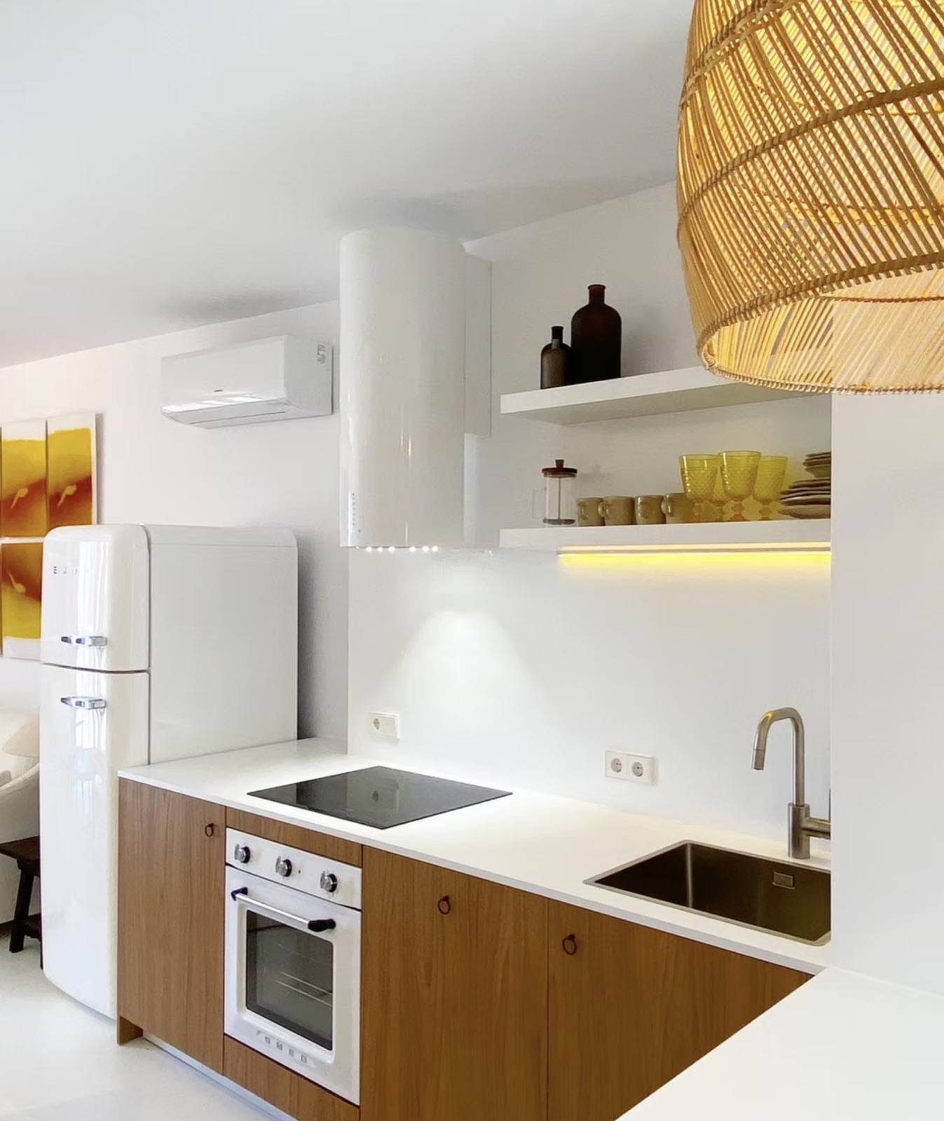 Compact bespoke kitchen in warm wood and white